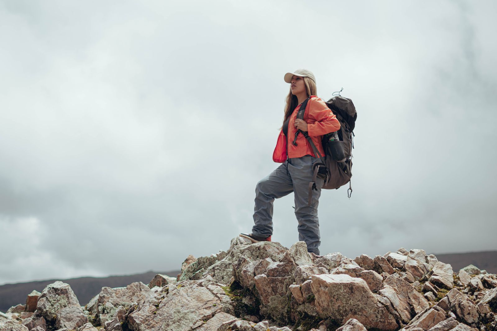 Female hiker with backpack on rocky terrain