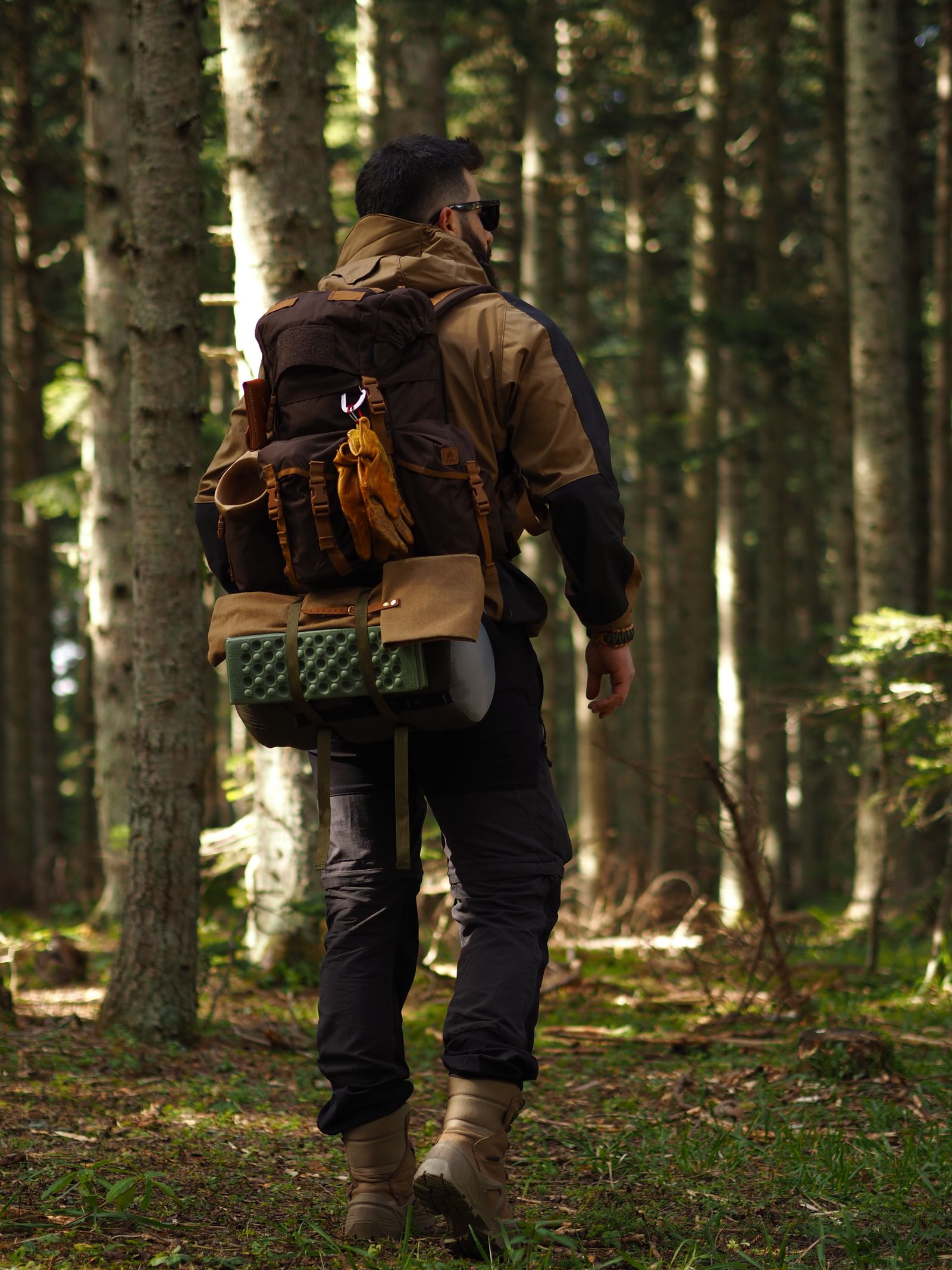 Hiker with a fully packed backpack on the trail